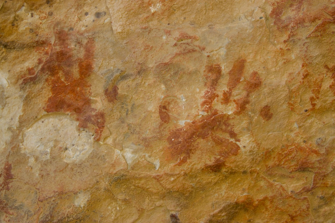 Ancient red ochre hand prints on a rock face
